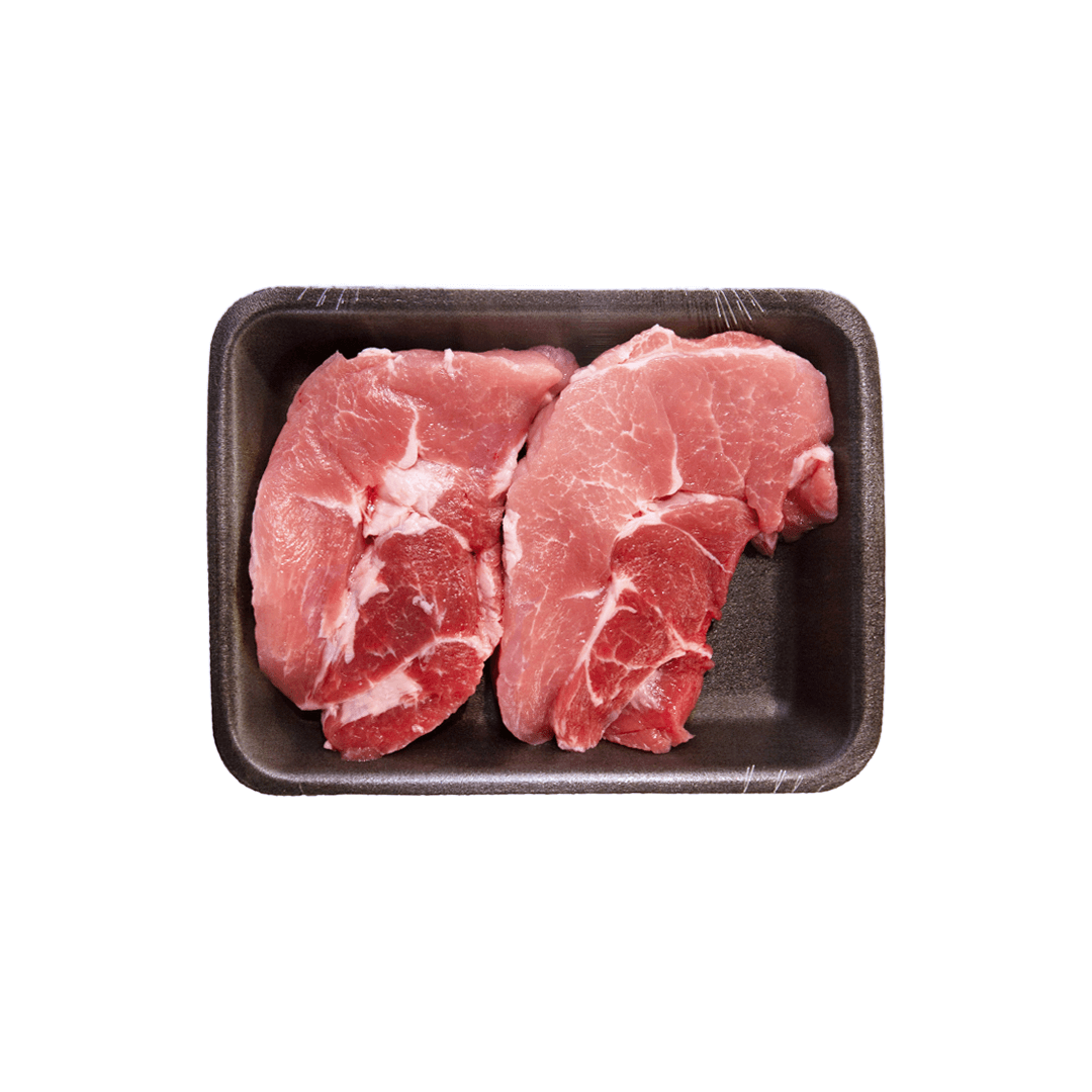 Raw pork chops on a black foam tray, isolated on white background.